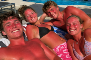 Sun burnt family smiling on the beach